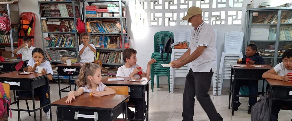 Pictured is Pastor Rodrigo Preciado serving the children at La Concha horchata (a Colombian creamy drink made of milk, rice, almonds, with cinnamon) as a treat.