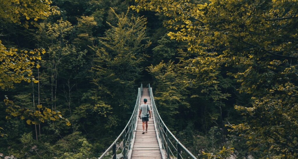 A person on a wooden footbridge.