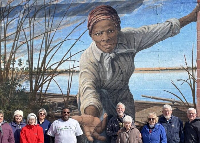The pilgrims stand before the Harriet Tubman Mural on an exterior wall of the Harriet Tubman Museum and Educational Center in Cambridge, Maryland. Artist Michael Rosato designed and painted the mural, which was completed in 2019. From left to right: Paul Knapke, JoAnn Knapke, Julie Hart, Rachel Gratz, Krisann Applegate, Alex Green (Harriett Tubman Tours tour guide), Philip Hart, Katherine Bauman, Marlene Suter, Scott Applegate, Conrad Gratz. Photo by Arloa Bontrager.