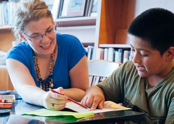 Melissa Kauffman tutors Alexander Porras as part of her work for the Migrant Farmworker's Project in Kansas City