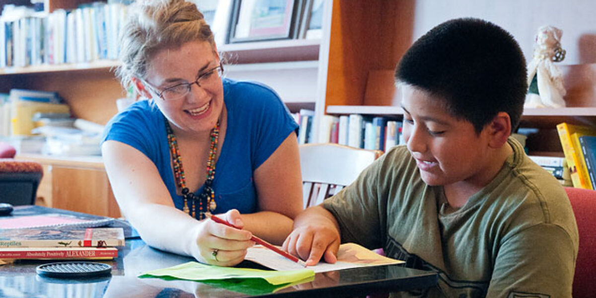 Melissa Kauffman tutors Alexander Porras as part of her work for the Migrant Farmworker's Project in Kansas City