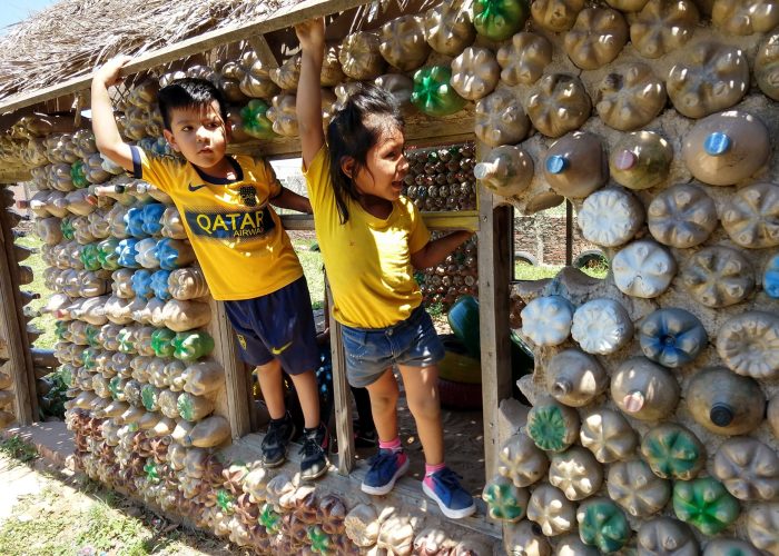 ​Children at Samuelito Daycare center prior to the pandemic enjoy climbing on their play house made of recycled materials. Families helped gather the materials and the center won a contest in the city of Santa Cruz for their environmentally friendly construction. Now some of the same children