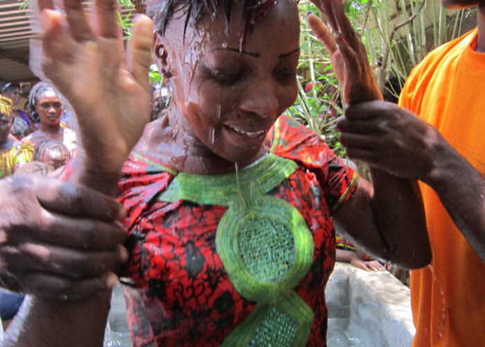 Lydie Yougbaré emerges from her baptism and into the fellowship of the Bobo Dioulasso congregation of Eglise Evangélique Mennonite du Burkina Faso (Evangelical Mennonite Church of Burkina Faso). Photo by Frank Nacanabo. Download full resolution image.