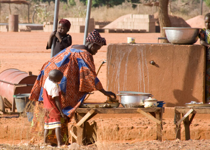 A woman in Burkina Faso prepares food.