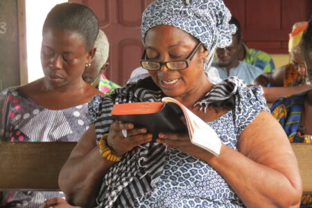​Bible classes on beach in Ghana taught by professors from Good News Theological College and Seminary. The wome nreading the Bible is Prophetess Mary Mensah from The Living Church of God. Photo by James R. Krabill.