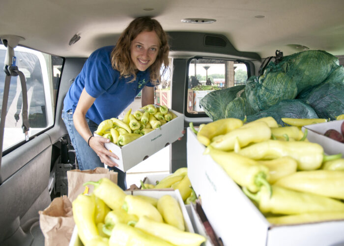 Katie Jantzen helps fill a van with fresh vegetables from a produce auction in Elkhart