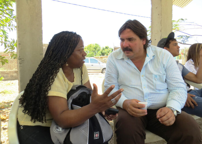 Zaraí Gonzalía (left) and Erwin Mirabal converse at Comunidad Cristiana del Camino in Espinal