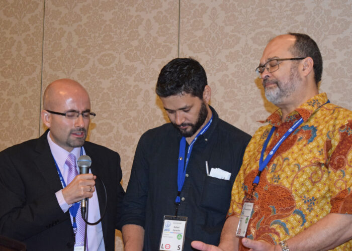 Cesar Garcia prays for Rafael Zaracho and Stanley Green