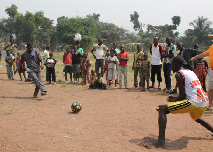 ​Robert Irundu demonstrates how to finish off a penalty kick during a Mennonite youth camp in Congo.
