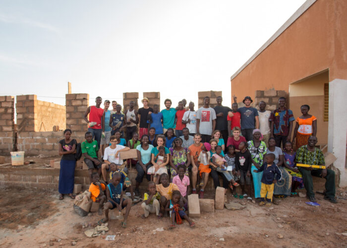 Mennonite youth from Burkina Faso and France take a break from building a school by the newly established Mennonite church in Coma