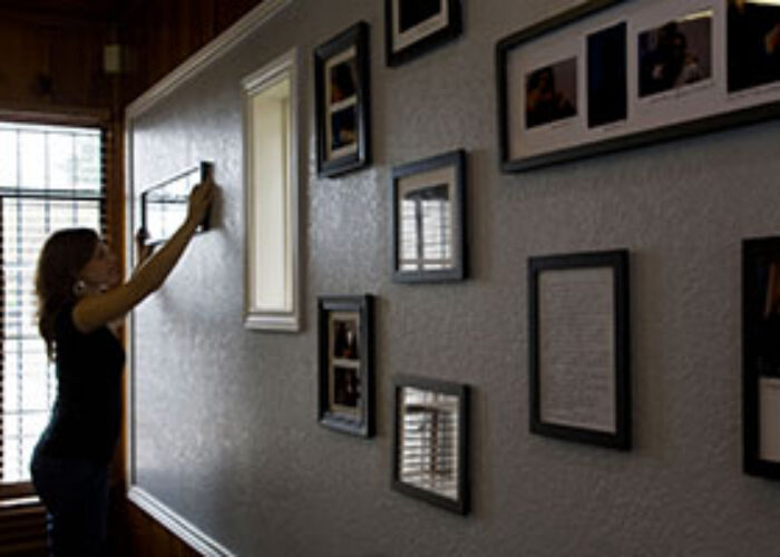Carrie Vander Hoek adds a photo to the wall at ProBAR.