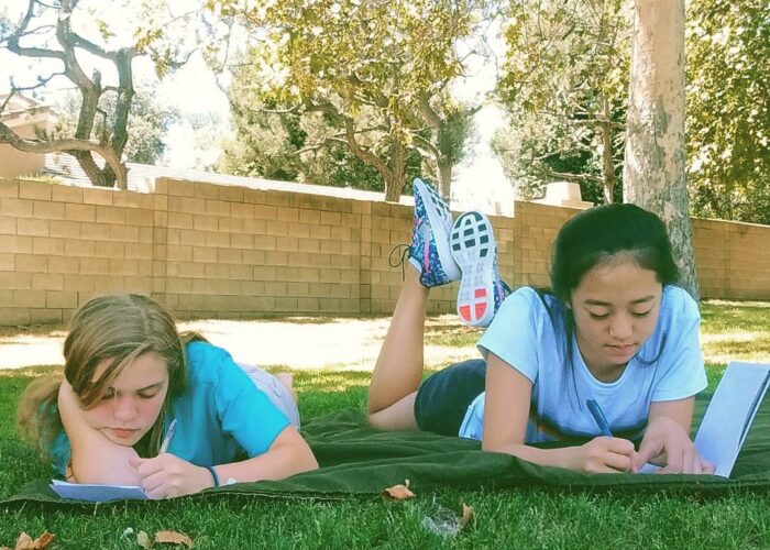 ​Elizabeth Eby and Celis Lee journal as part of their participation in the LA Peace camp