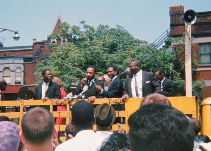 ​Martin Luther King, Jr. speaks to a crowd before a march in Chicago. Photo by Neill von Gunten.