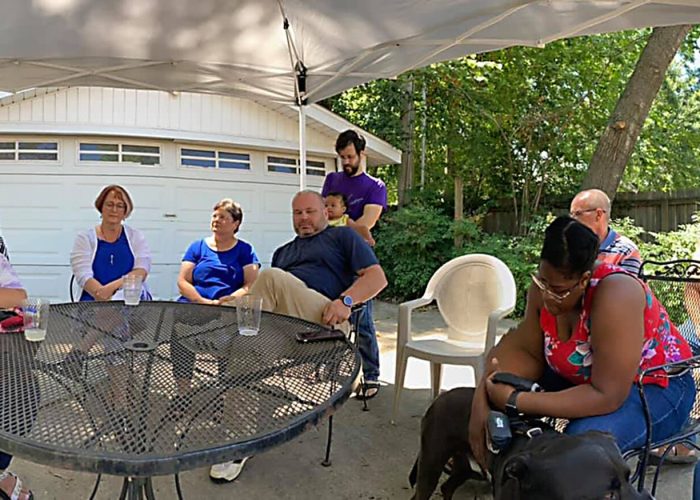 Pastor Horace McMillon and members of Open Door Mennonite Church participate in a blessing of Service Adventure participants Malachi Lind and Jocelyn Baker at the end of their time of service in Jackson