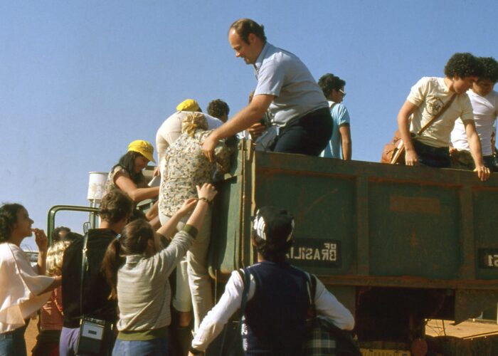 ​Erwin Rempel helps Venancia de Almeida climb into the vehicle that will carry 50 Mennonite youth from the Gama and Ceilandia congregation to a retreat. Photo provided.
