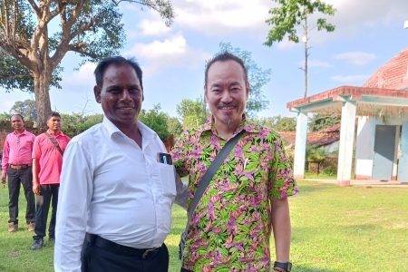 Rev. Suleman Tigga and Andi Santoso in front of Bihar Mennonite Mandli church, Bathet, India.