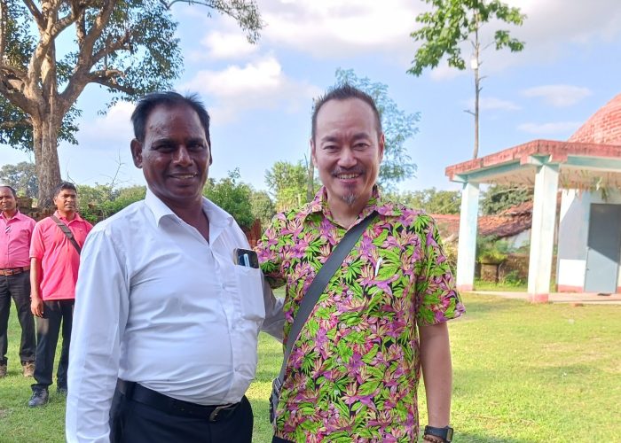 Rev. Suleman Tigga and Andi Santoso in front of Bihar Mennonite Mandli church, Bathet, India.