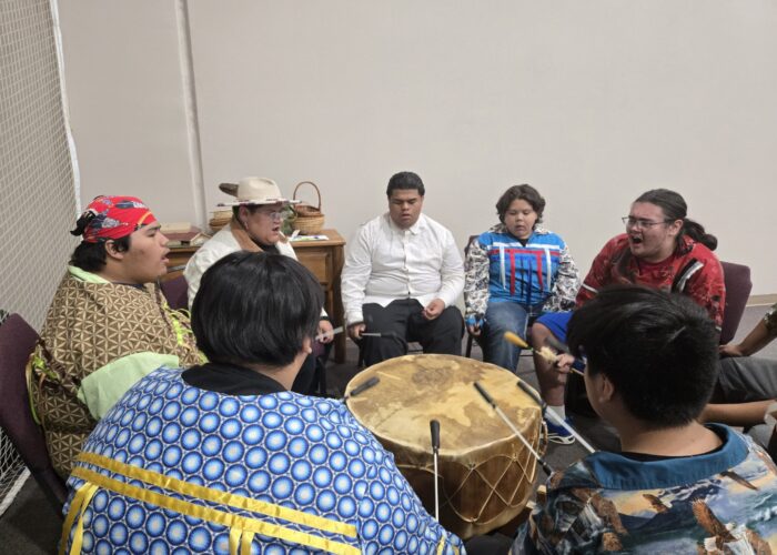 Dewy Bell, third from left, leads the Mending Wings singers and drummers. Photographer: Sarah Augustine.