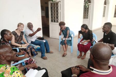 Anicka Fast (third from left) listens as Felo Gabriel talks with fellow biography-workshop writers in Kinshasa, DRC about choosing their biography subjects. Photo provided. 