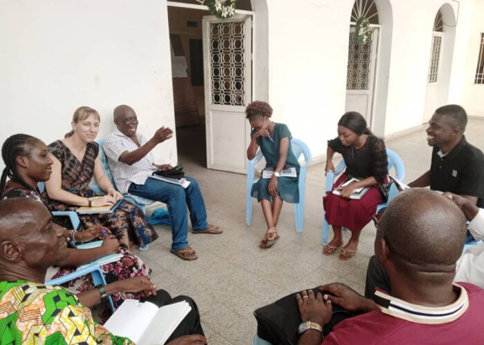Anicka Fast (third from left) listens as Felo Gabriel talks with fellow biography-workshop writers in Kinshasa, DRC about choosing their biography subjects. Photo provided. 