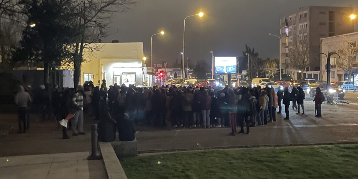 A group gathers in Calais to commemorate the deaths of refugees.