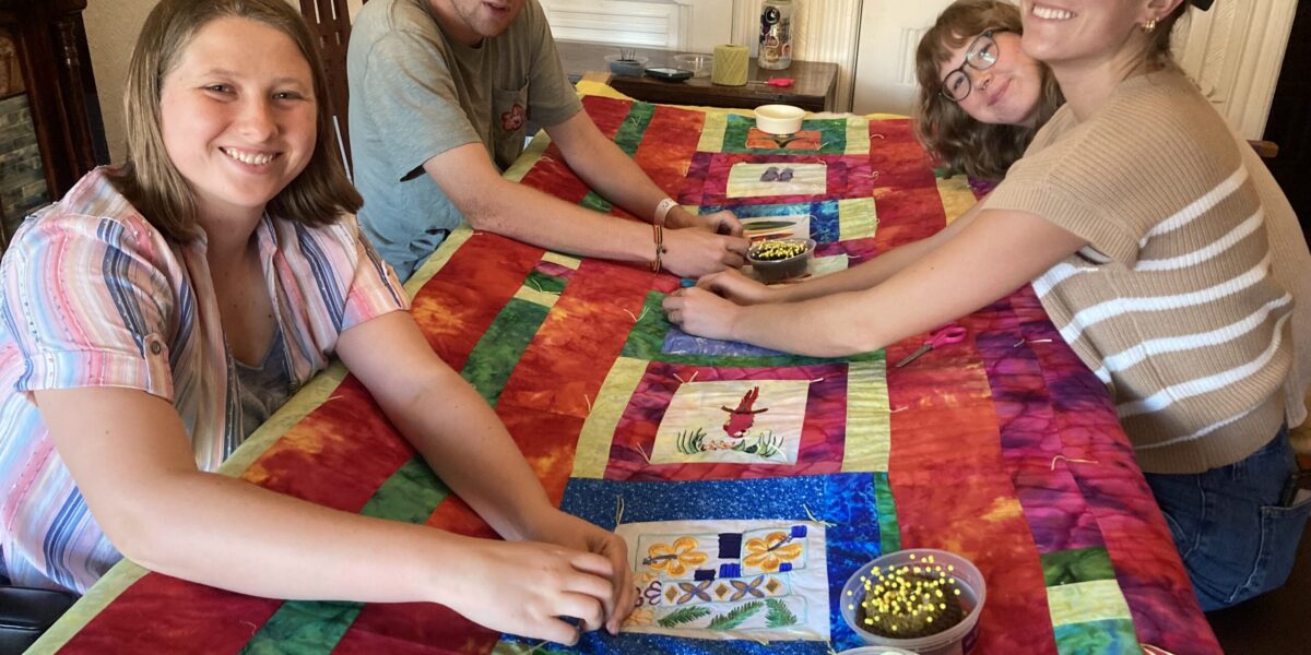 Each year, the San Francisco MVS unit is invited to gather together and craft comforters for themselves. Karen Kreider Yoder, a member of the unit's host congregation, First Mennonite Church of San Francisco, hosts the group at her home for this annual tradition. At the end of the day, each participant takes home their own cozy comforter to use during their service term and beyond! Left to right: Ana Neufeld Weaver, Keyan Krabill, Emmi Scott and Bella Kephart. Photo by Karen Kreider Yoder.