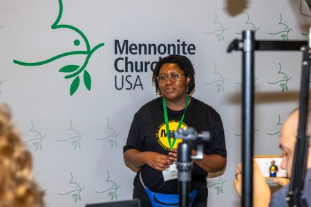 ​Faith Bell at the MC USA booth at MennoCon21. Photo by MC USA Communications.