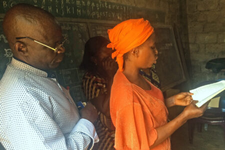 Claudine Lutondo of Kinshasa reads the Bible in Lingala. Photo provided by AIMM.