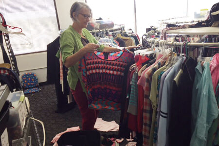 Betty Histand sorts clothing at International Rescue Committee's clothing distribution center in Phoenix