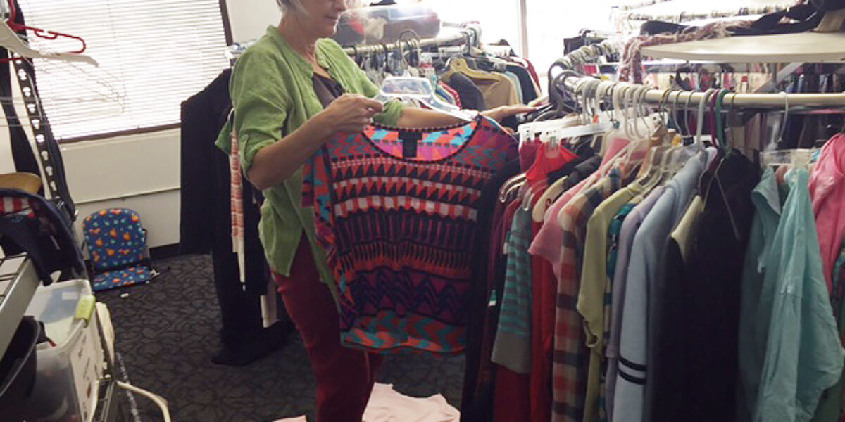 Betty Histand sorts clothing at International Rescue Committee's clothing distribution center in Phoenix