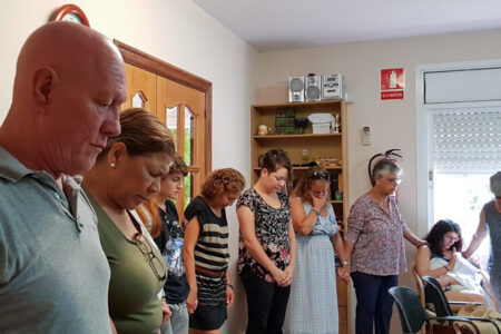 Members of Comunidad Evangélica Menonita in Barcelona gather for prayer on Sunday