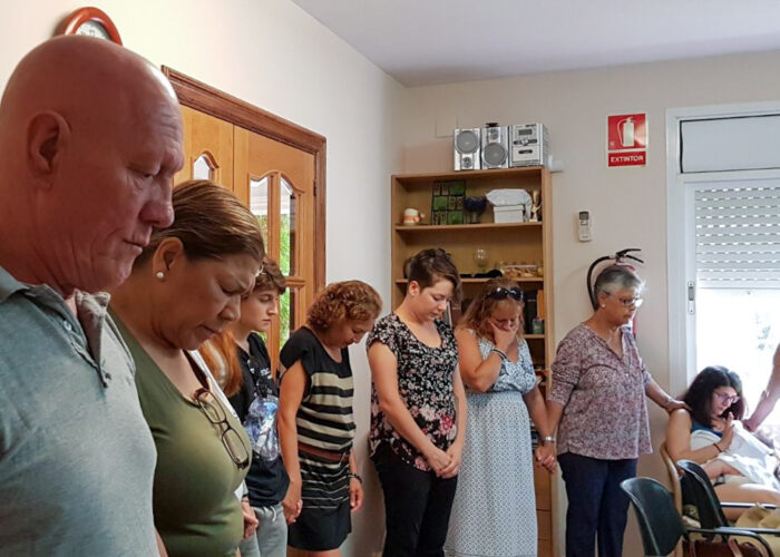 Members of Comunidad Evangélica Menonita in Barcelona gather for prayer on Sunday