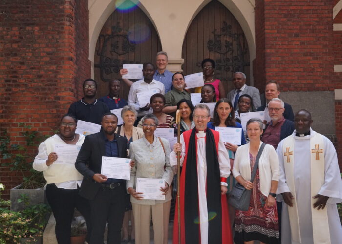 ​The first graduates of Holy Trinity Brussels' peace and conflict transformation program celebrate with Sharon Norton and Jean-Bosco Turahirwa (first row
