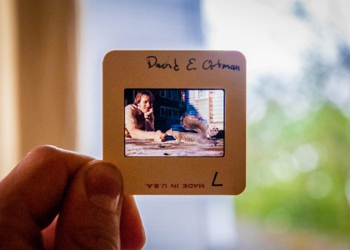 ​David Ortman feeds a squirrel outside the unit house in one of the many slides present at the MVS Seattle celebration. Ortman was an MVS Seattle participant 1975-1977 and 1978-1980. Photo by Greg Thiessen.