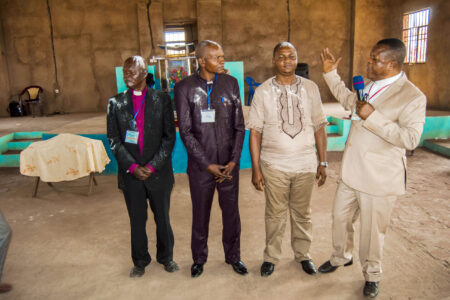 Standing at far right