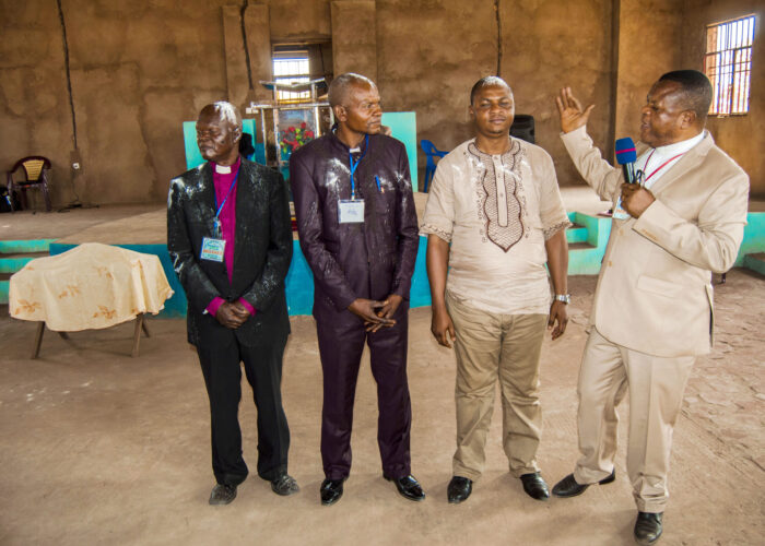 Standing at far right