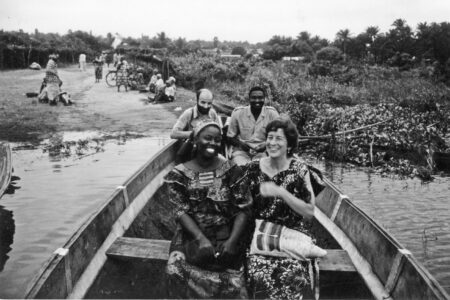 From back left, Daniel Goldschmidt-Nussbaumer, a Mennonite Board of Missions doctor from France, and Saturnin Afaton, a Beninese lawyer. From front left, Rebecca Assani, an Apostolic Church educator, and Lynda Hollinger-Janzen begin a river crossing in a pirogue (dugout canoe) during a community health trip to Gbeko in 1987.
