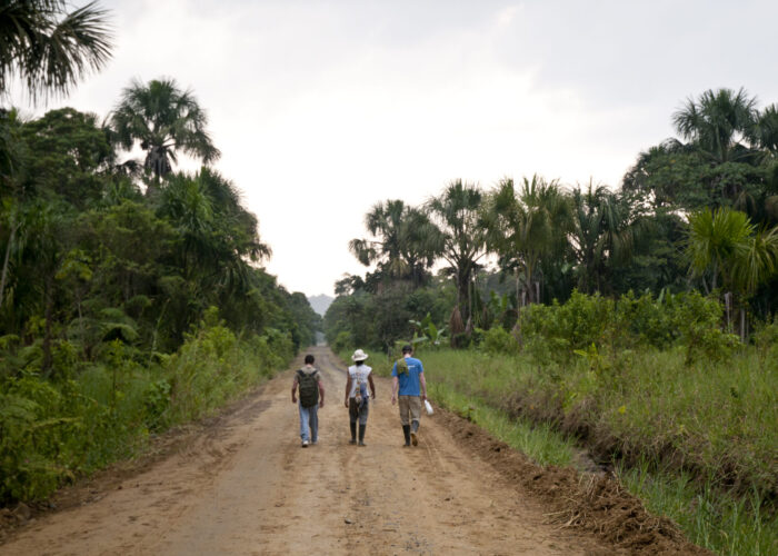 Three men walking down a path