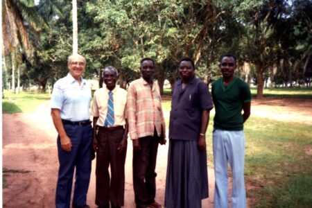 ​Earl Roth (left) greets Chief Nyanga (second from right) and other friends on an administrative trip to Congo in 1993. Photo from MCUSA archives.
