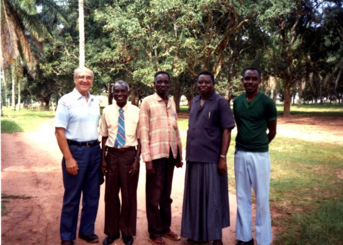 ​Earl Roth (left) greets Chief Nyanga (second from right) and other friends on an administrative trip to Congo in 1993. Photo from MCUSA archives.
