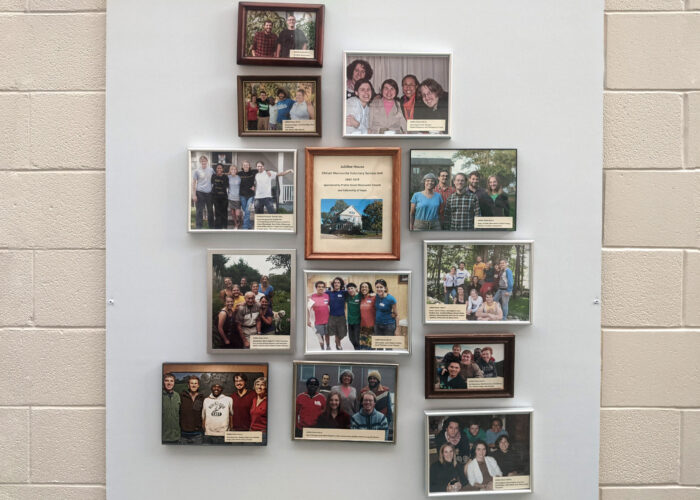 ​Photos of the MVS unit participants hang in a foyer at Prairie Street Mennonite Church. Photo by Zachary Headings.