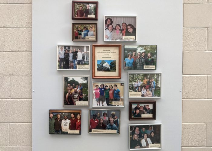 ​Photos of the MVS unit participants hang in a foyer at Prairie Street Mennonite Church. Photo by Zachary Headings.