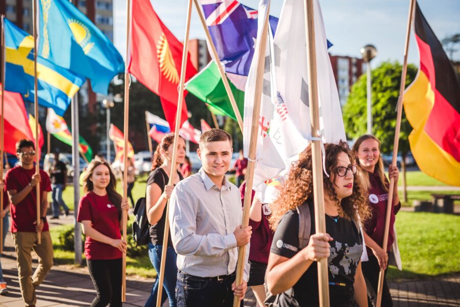 LCC students carry flags to represent their home countries.