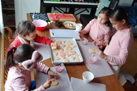 ​Jae Young Lee and Karen Spicher's children frosting Valentines Day cookies. Photo by Jae Young Lee.