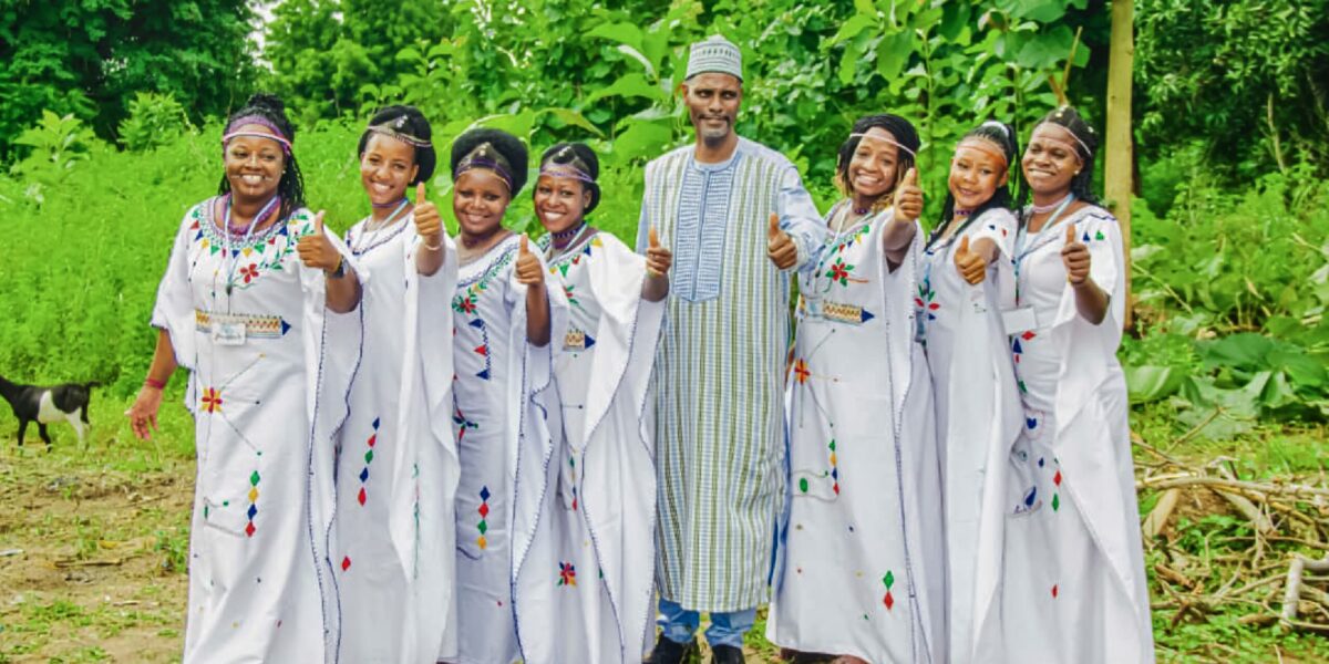 Daniel Dama (center) poses with members of a music ensemble during a festival in Djougou, Benin, in August 2025. Photographer: Bill Harris
