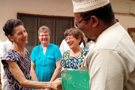 ​Janet Stucky receives congratulations from Dr. Barthélemy Dossou-Bodjrenou