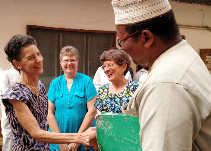 ​Janet Stucky receives congratulations from Dr. Barthélemy Dossou-Bodjrenou