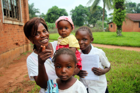 ​Tshiela Kalonji takes a break from her studies at Kalonda Bible Institute with three of her five children. Photo by Charles Buller.
