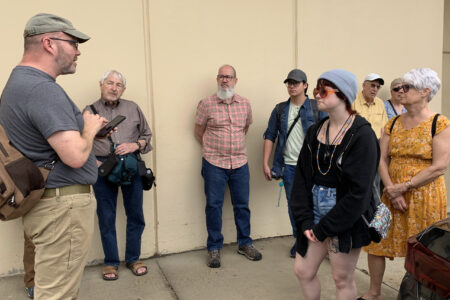 ​Pastor Hugh Hollowell Jr. of Open Door Mennonite Church leads the civil rights learning tour participants on a walking tour of Jackson