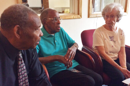 Left to right: Charles Marshall, Gerald Hughes, and Annabelle Hughes converse after the anniversary celebration. All three are original members of the church. Photo by Ann Jacobs.